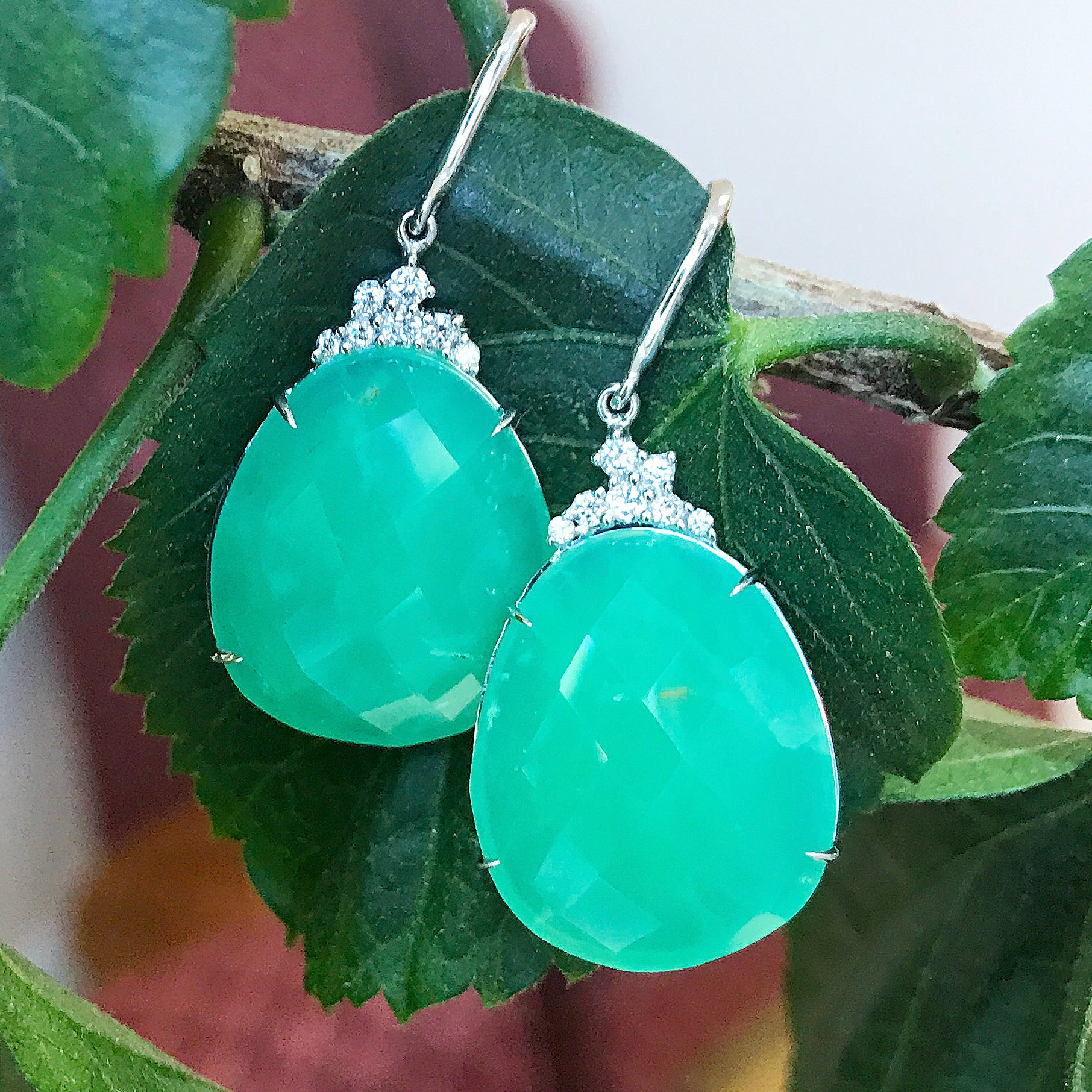green gemstone drop earrings with diamond accents